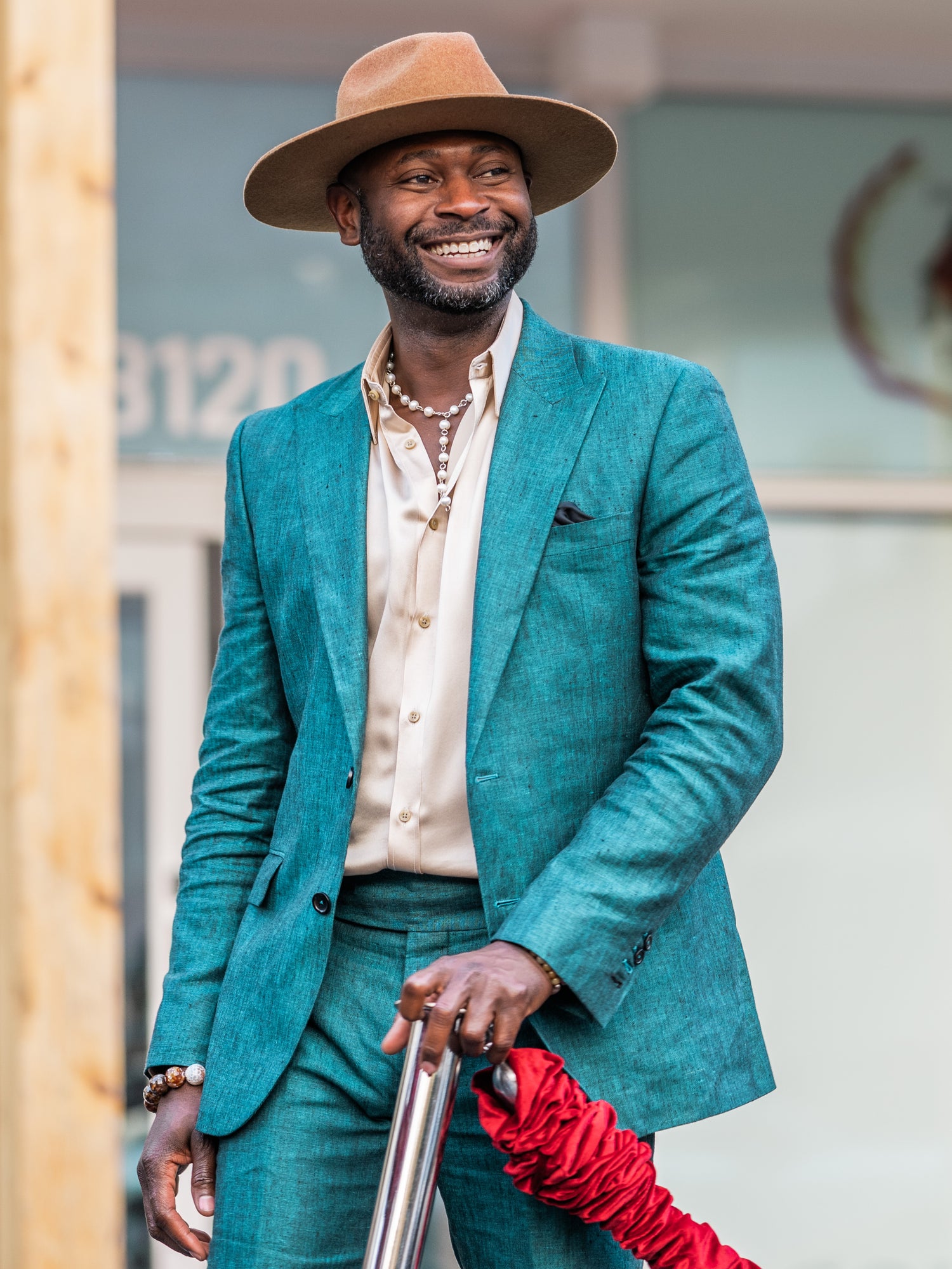 Tony Ike, the mastermind behind The House Of Rose, elegantly clad in a blue bespoke linen suit jacket